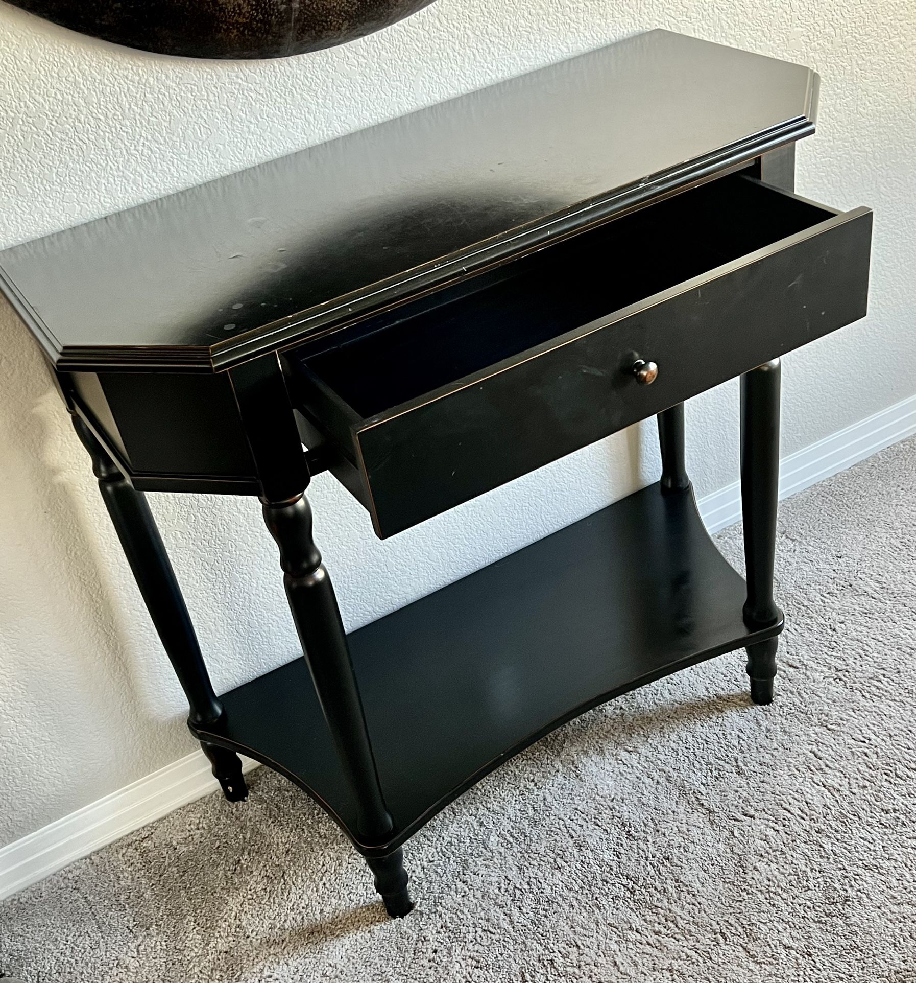 Gorgeous entry hall or console table in a deep burnished espresso. Sleek lines and beautiful legs. Large drawer for storage in addition to shelf for d