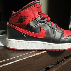 Air Jordan 1 Mid “Bred” (Black/Red) sneakers.