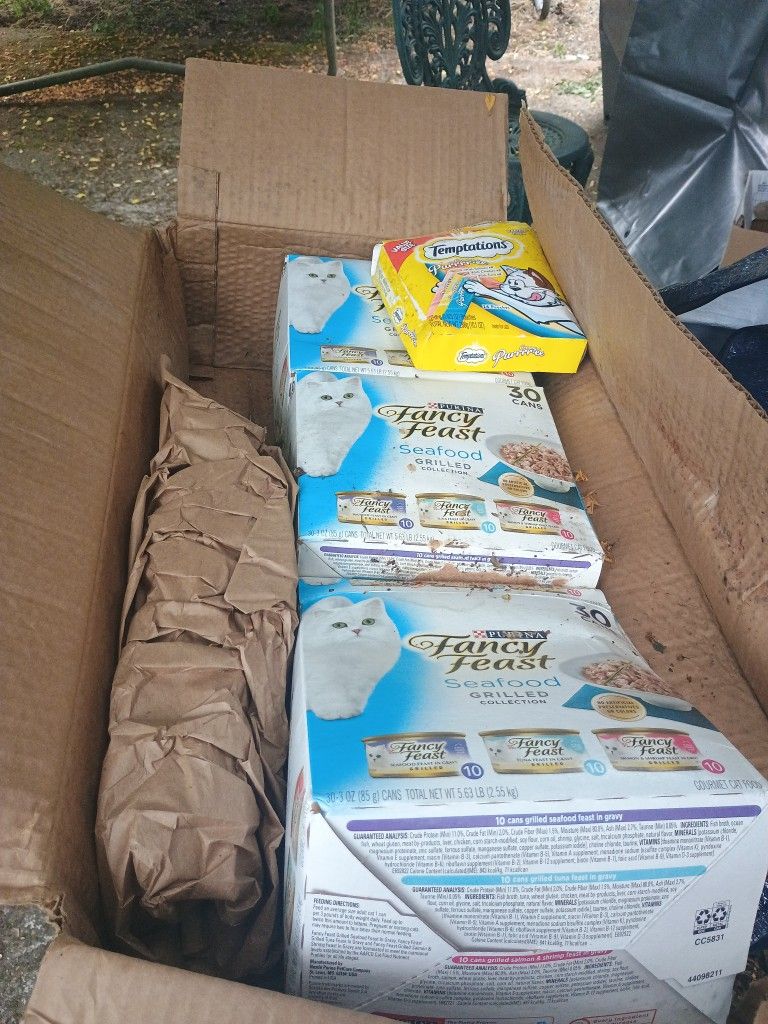 boxes of cat food and a box of purree