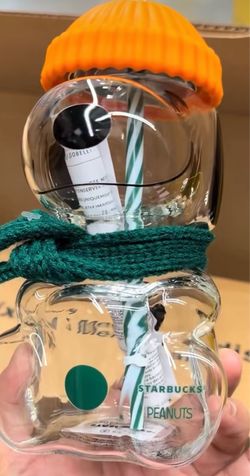 The Snoopy™ Glass Cold Cup features a charming Woodstock™ straw topper, pumpkin-colored hat and a seasonal green scarf. $100 OBO