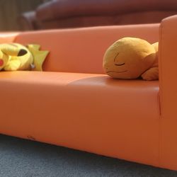Orange Couch “WE DELIVER”