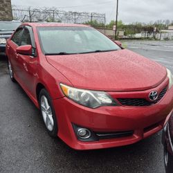 4 door red Toyota Camry. 