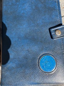 AA big book and twelve step book with blue leather book holder and AA SOBRIETY CHIP HOLDER IN FRONT