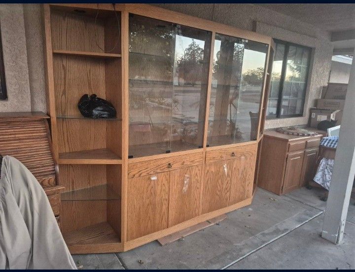 wooden display cabinet with glass doors and shelves.