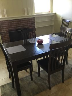 Handsome dark wood dining room table with 6 matching chairs.