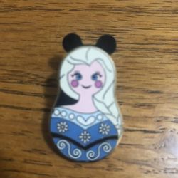 Collectible Disney pin Nesting Dolls Collection Elsa Frozen Mystery Pin.  Size 3/4 inches wide and 1 1/4 inches long. Purchased at Disneyland.  Has be