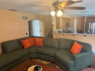 Large Gray Sectional Sofa with Orange Pillows