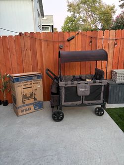 WonderFold W4 Multi-Function Folding Quad Stroller Wagon with accessories and travel bag