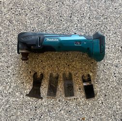 Makita XMT03 oscillating multitool with 4 drywall blades