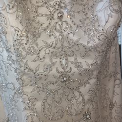 Oleg Cassini White bead embroidered wedding dress Size 10 Ivory mermaid style with a sweetheart neckline

Condition is used with a couple small tears 