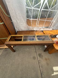Console table with brass-trimmed glass panels