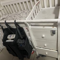 Baby Crib with changing Table, 2 mattress, and diaper hold in the front of it 