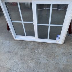 window, vinyl double glass with grids  used window  opens side to side slider Height 29 1/2inches Width 35 1/2