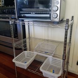 Kitchen chrome 3-tier shelf storage rack, Breville stainless steel toaster oven, small plastic organizer bins