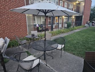 metal  table and 2 chairs  and umbrella 