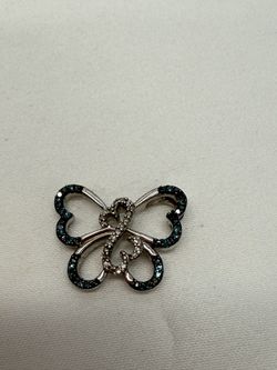 Silver Butterfly-shaped pendant decorated with blue and white stones