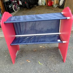 A Little Boy Stand With Shelves