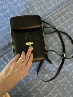 Stylish black leather crossbody bag with gold accents.