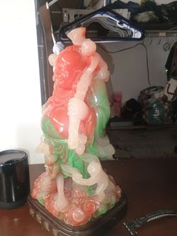 Laughing Buddha pixie blown glass beautiful colors red white and green on a wooden stand