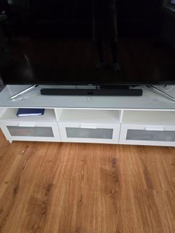 Samsung 75 inch TV with a Samsung sound bar and entertainment center