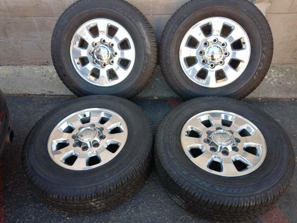 Four 18 inch GMC rims and tires 8 on 180mm