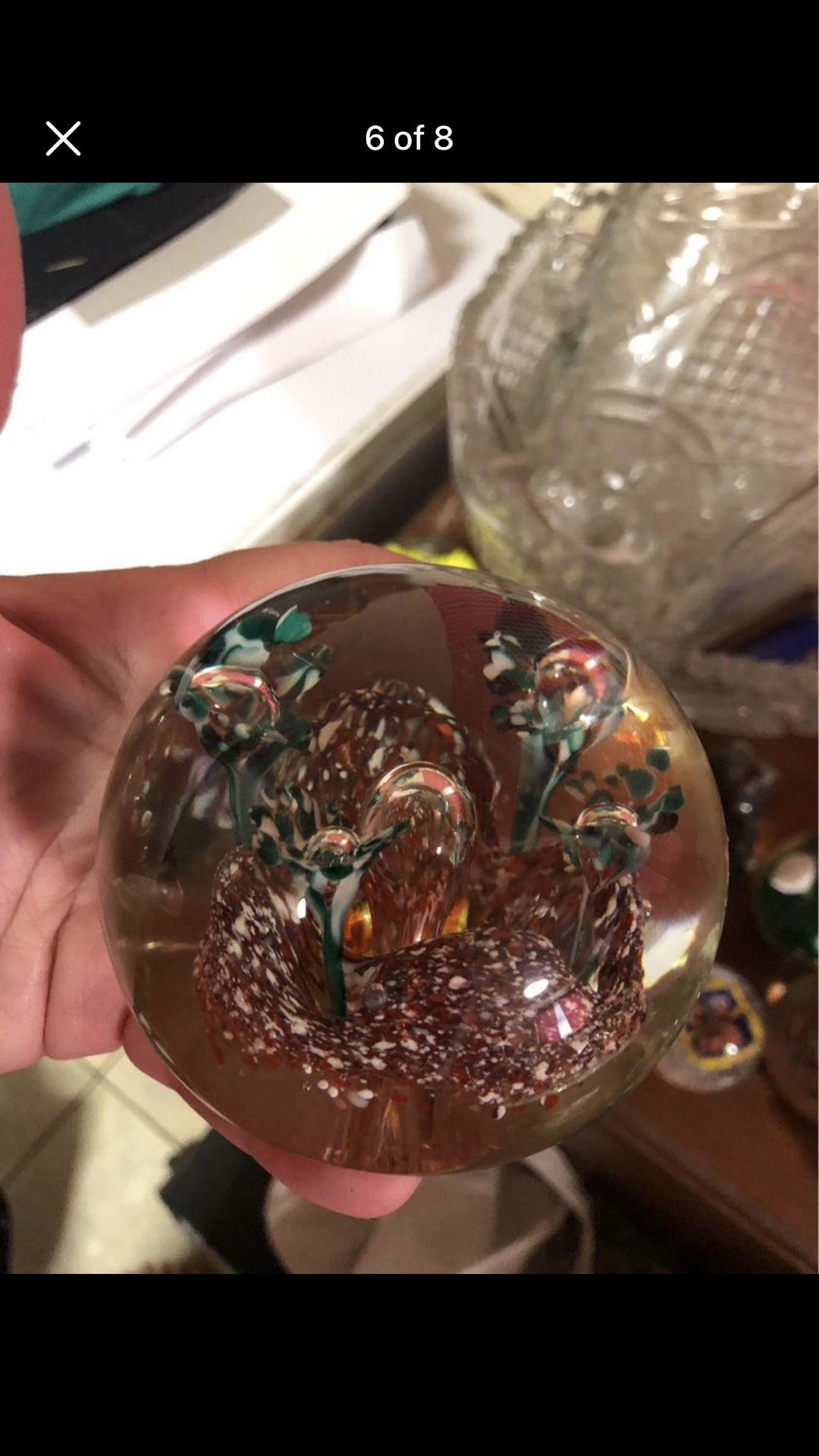 Vintage clear glass paperweight with red and green flowers inside