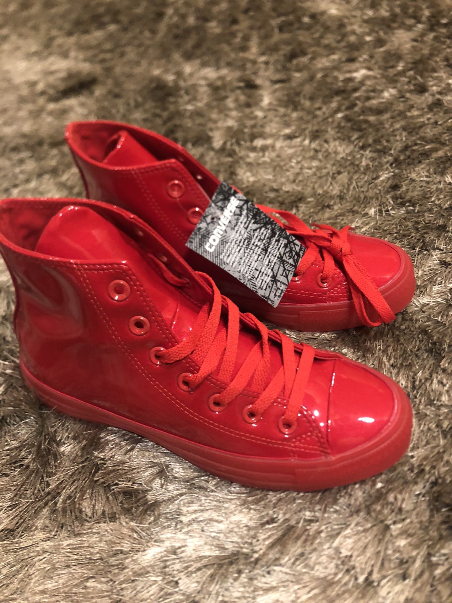 Woman’s brand new patent leather Converse Sneakers.