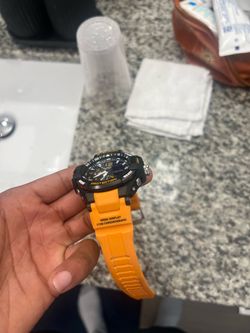 Black and orange g shock watch