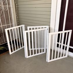 2 white freestanding pet gates