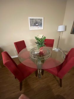 Round Glass Dining Table with 4 Red Chairs