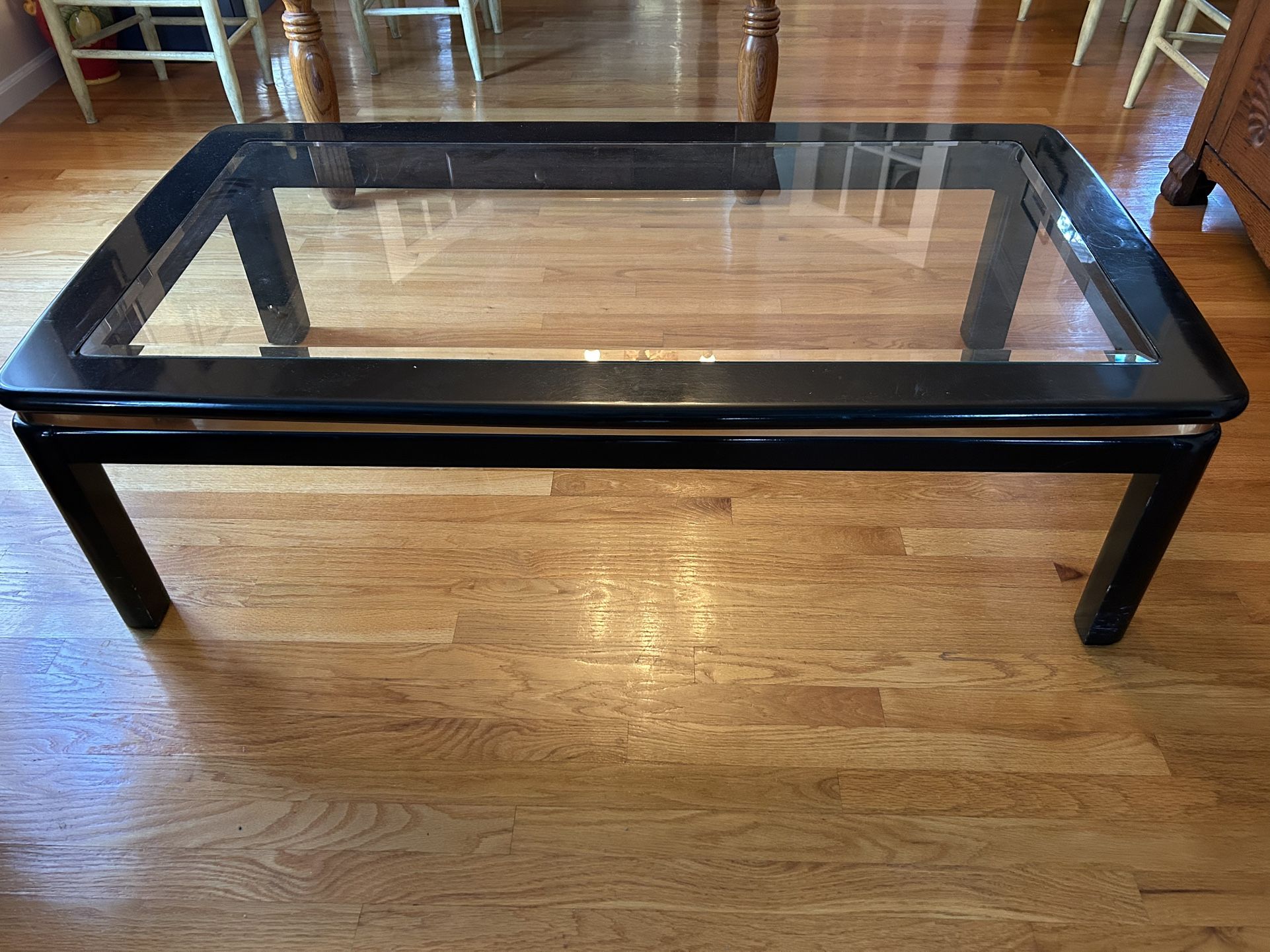 1970s Lacquer Coffee Table with beveled glass top and gold metal trim around edge