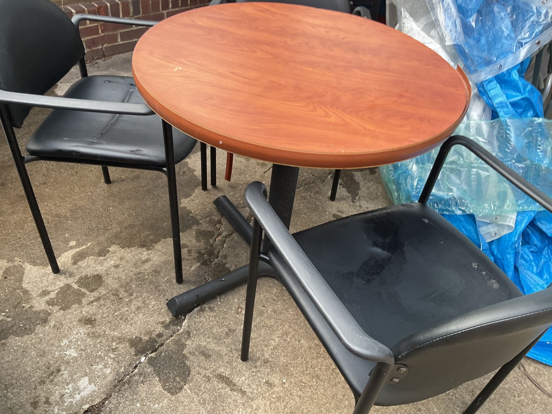 A Round Table 30” Diameter, With 3 Black Chairs, In Good Conditions