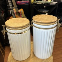 Set of ceramic kitchen canisters with wooden lids and metal latches