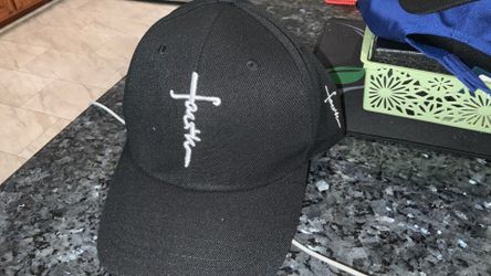 Black adjustable ball cap with White “Faith” Cross