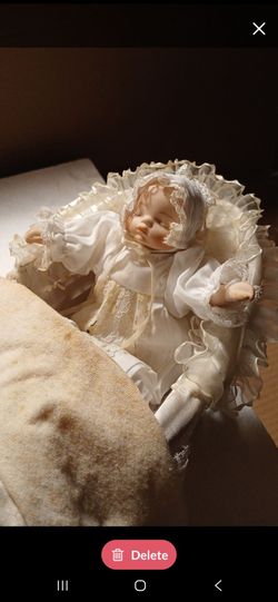 Porcelain Baby Doll in Vintage Pram