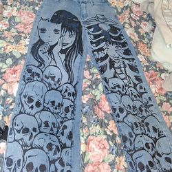 These jeans are the ROMWE Anime Figure Graphic Straight Leg Jeans featuring a distinctive skull and character print.