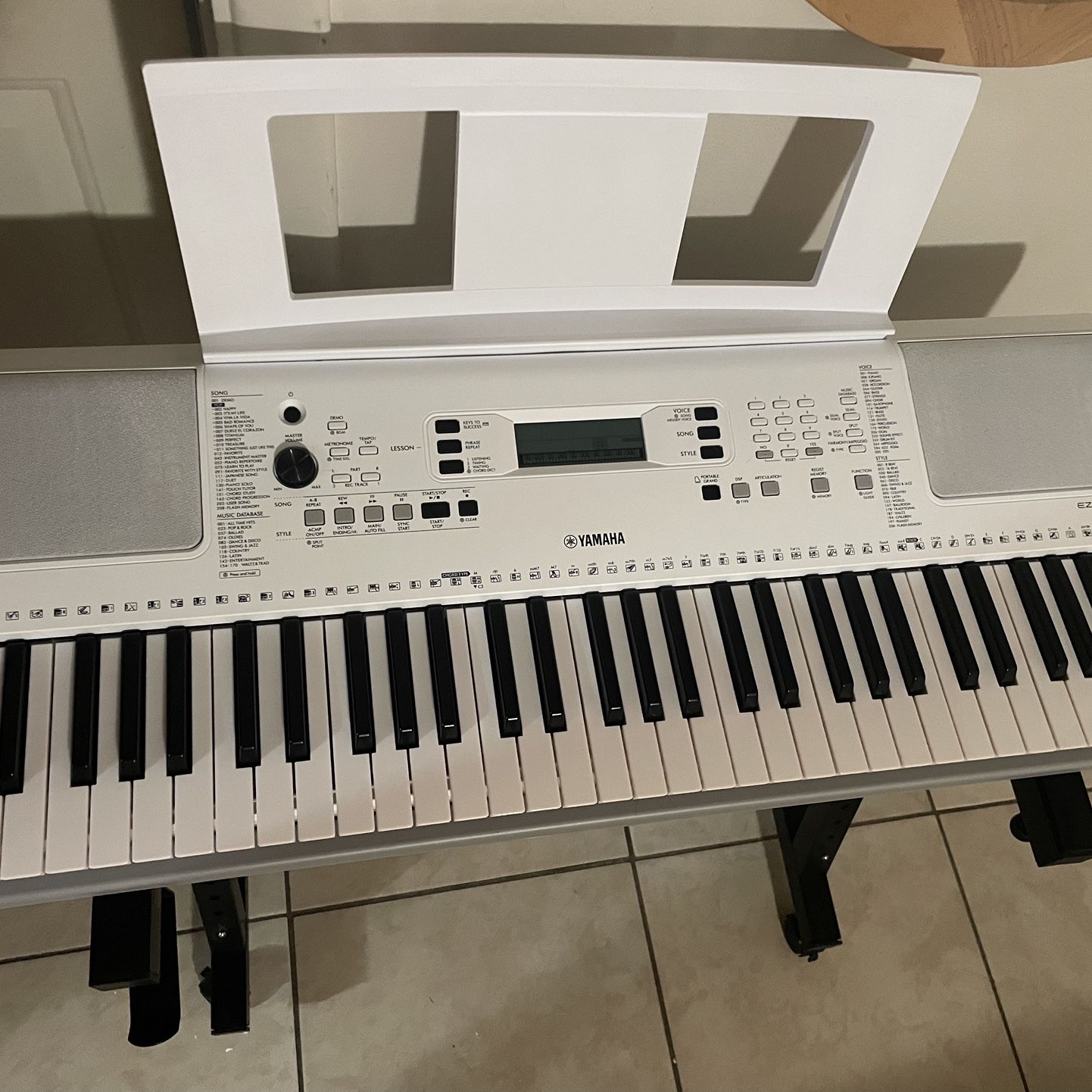 Yamaha EZ-300AD keyboard with lighted keys, plus adjustable keyboard stand with wheels: