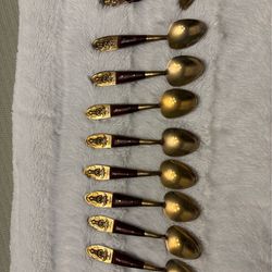 Set of eight vintage Siam Buddha brass and wood teaspoons and one jelly spoon