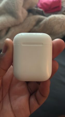 Apple AirPods Charging Case & 1 right AirPod.