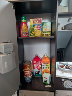 Kitchen set with lots of Melissa and Doug items