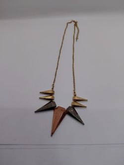 This is a Hot Topic Spiked Silver Costume Necklace in a gold-toned finish with mixed metal spikes.