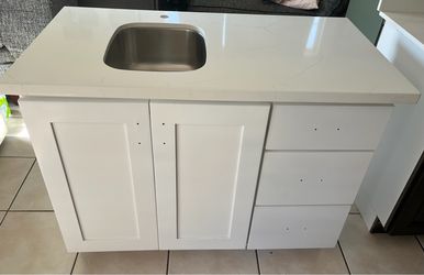 Kitchenette with quartz countertop and sink