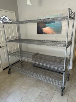 Heavy duty Storage Rack Nexel 4 shelve 72 wide X 24 deep X 69 height. Polyurethane stem casters, 4 swivel.