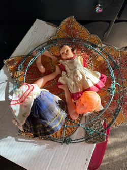 Wreath and two broken vintage dolls