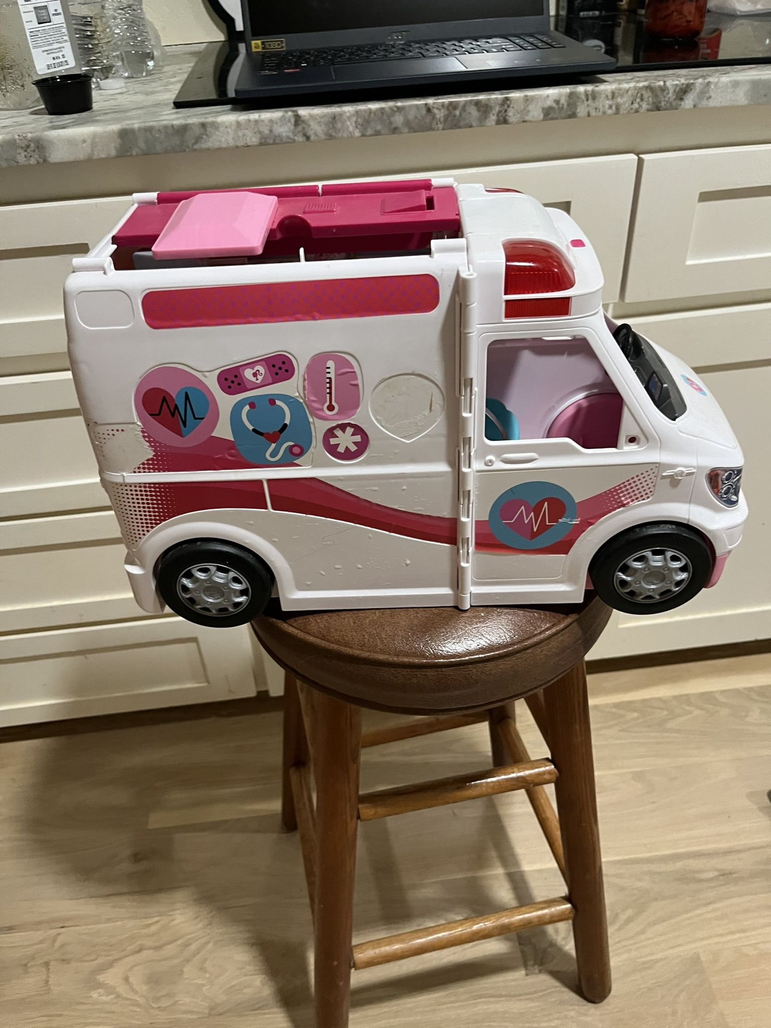 BARBIE AMBULANCE; there is a piece missing on the top; cross streets are Arapaho & Waterview