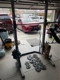 Squat rack with bench, barbells and weights
