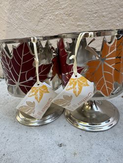New! Set of two metal candle holders with autumn leaf design.