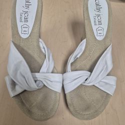 pair of white Cathy Jean Brazil leather upper wedge sandals.