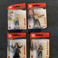 4 New Small WWE Plastic Action Figures On Stands
