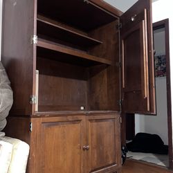 Spacious wooden cabinet with shelves, Doors and a pullout Table